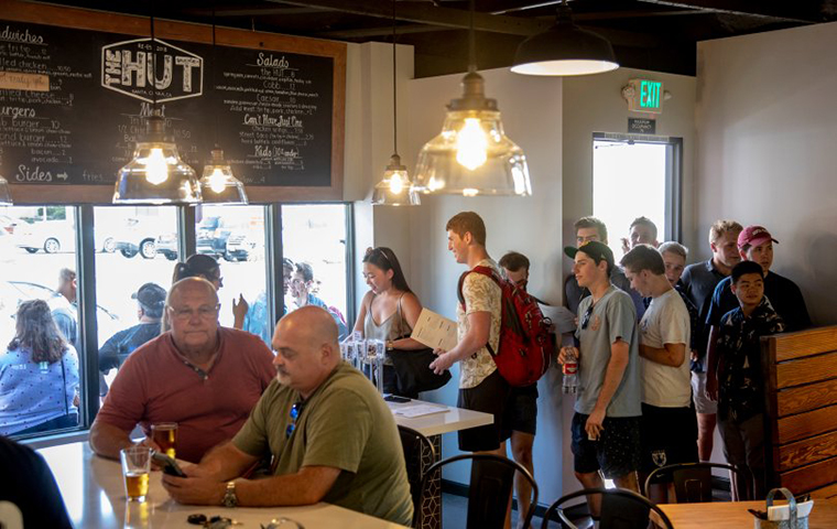 Students walk into The Hut