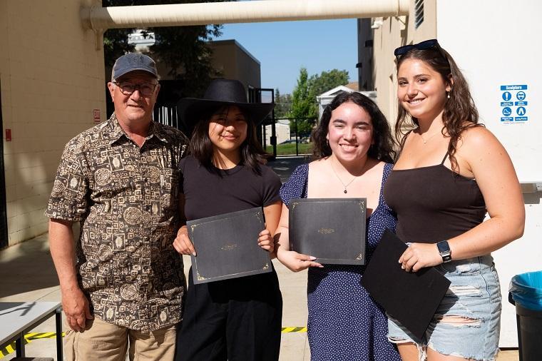 Kelly Detweiler with three student recipients