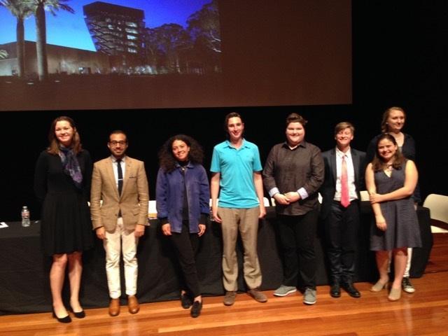 A group of people on stage at an art history symposium.