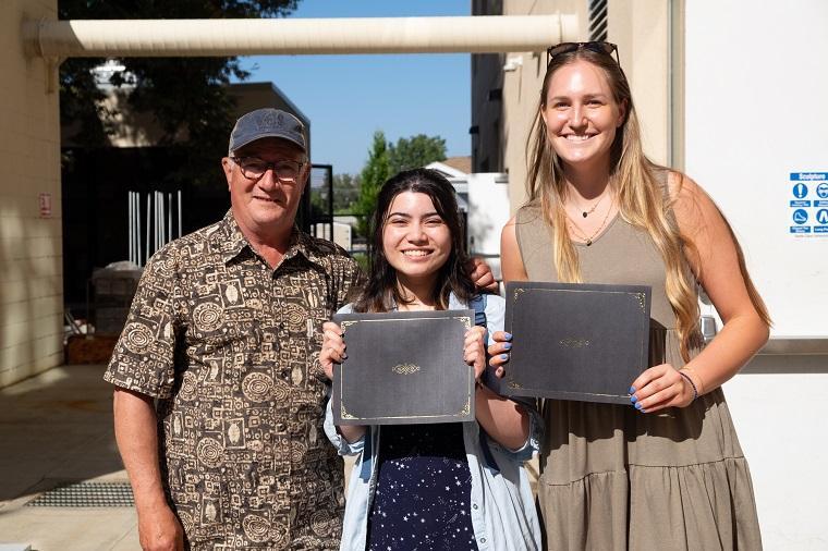 Kelly Detweiler with two student recipients