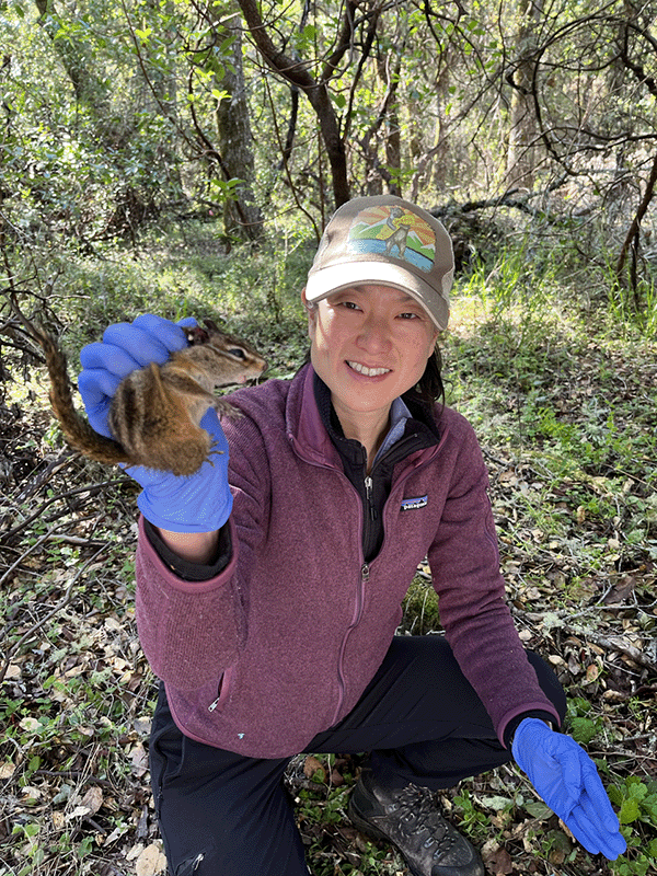 Andrea Swei holds a chipmunk outdoors.