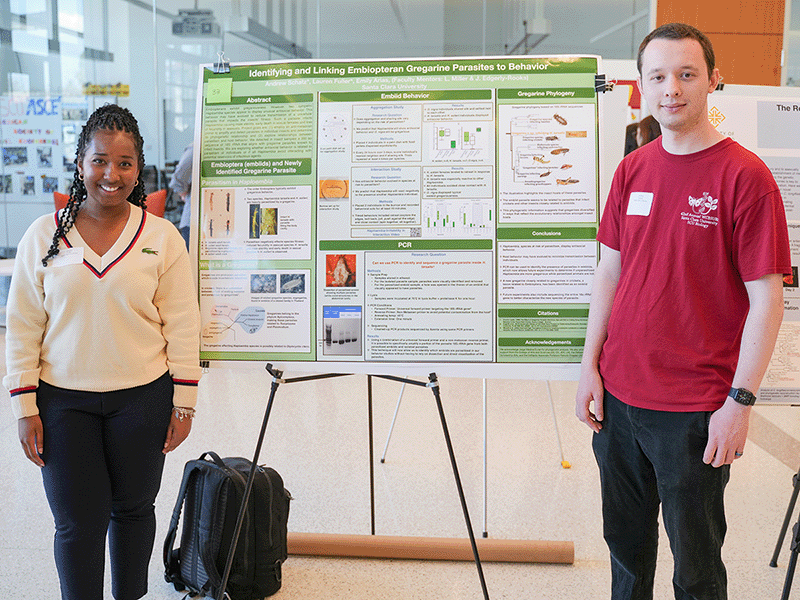 Students standing by their poster