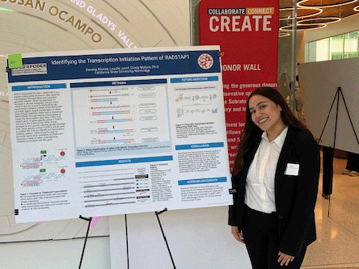 A student stands by her poster