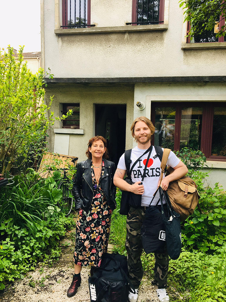 Brendan Webb and friend outside a home