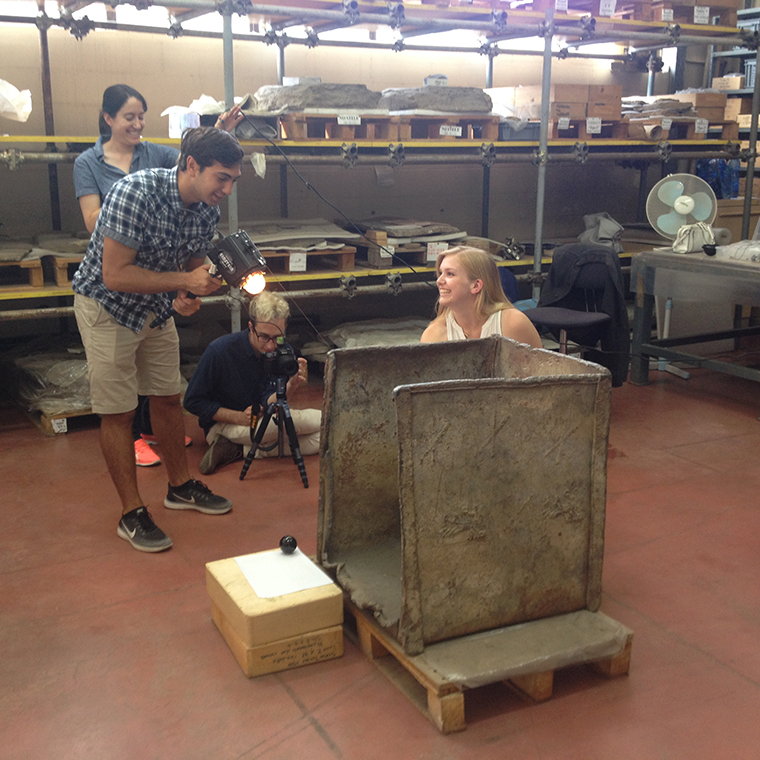 Man leading a workshop with students in an industrial setting.