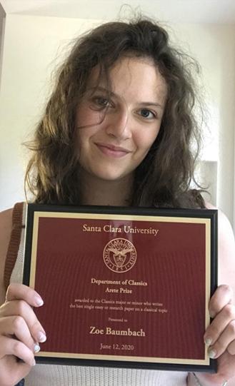 A person is holding a framed certificate from Florida State University College of Music.