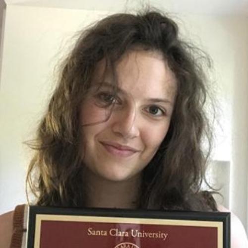 A person is holding a framed certificate from Florida State University College of Music.