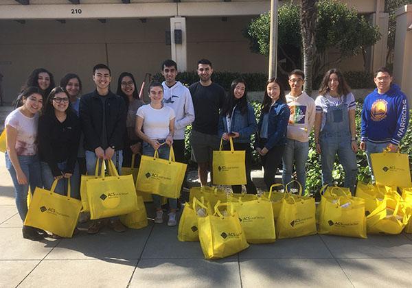 Club members lined up with yellow bags