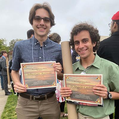 Sebastian Acevedo and D'Angelo Castillo holding awards