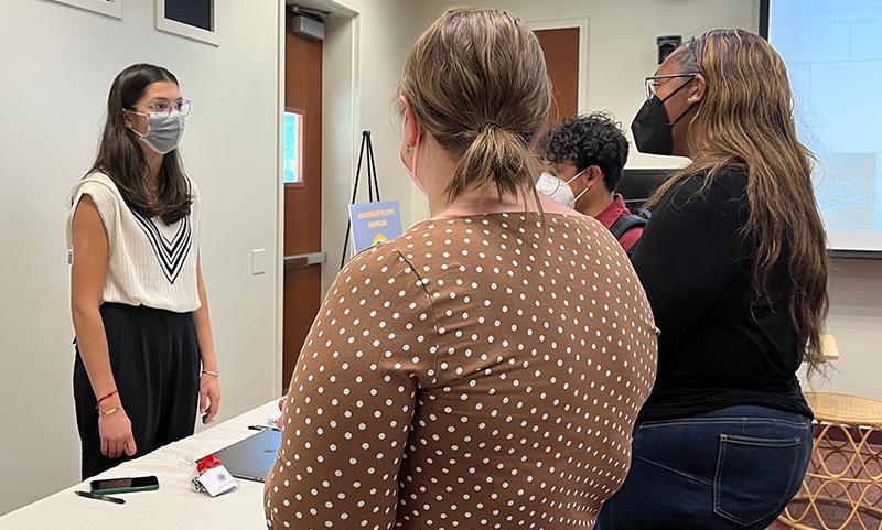 Natalie Henriquez discussing her project at the CAH Student Fellows Showcase.