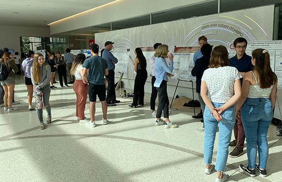 Students presenting posters to other students and faculty