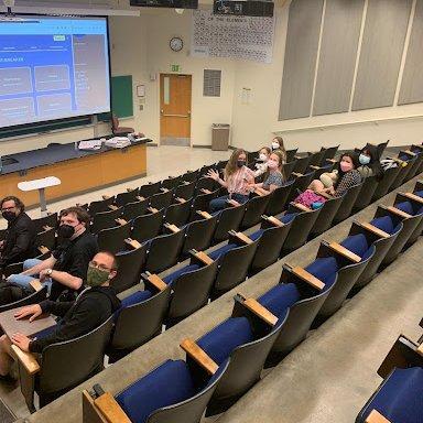 History club meeting with students in seats in front of projector