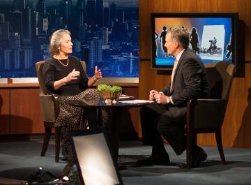 Two people having a TV interview in a studio.