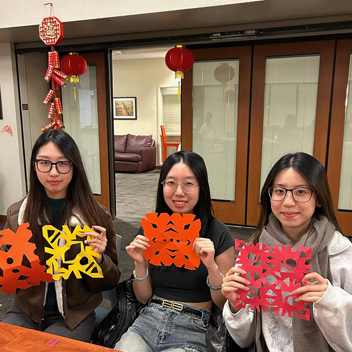 Students with their cut art work during the 2024 Lunar New Year celebration