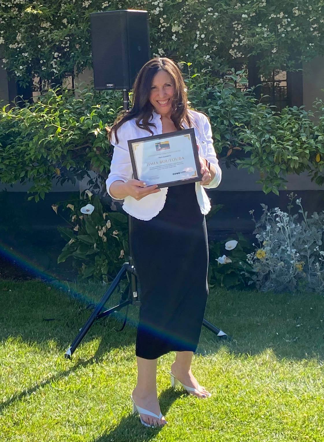 Jimia Boutouba holding her SCU Career Center award for Outstanding Career Influencer.