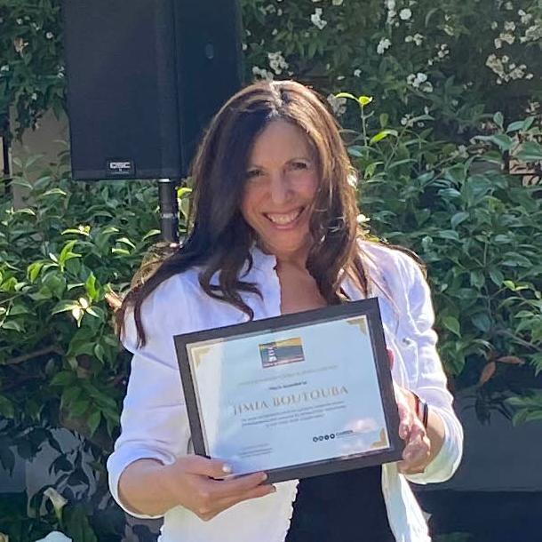 Jimia Boutouba holding her SCU Career Center award for Outstanding Career Influencer.