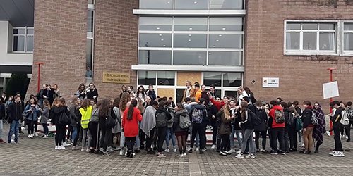 Group in front of school entrance