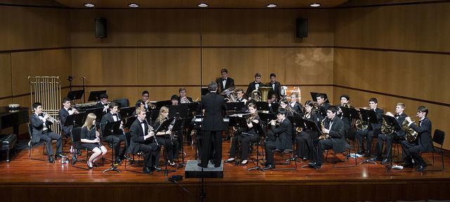 Wind ensemble playing in a theater 