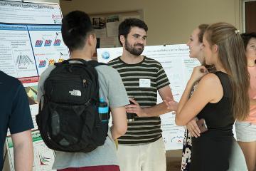 Three people having a conversation in a casual setting.