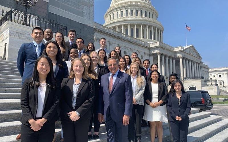 Group of interns posing on steps in front of the U.S. Capitol building.