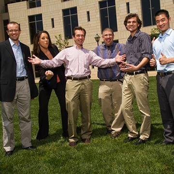 Tom Plante and lab members Group of six people standing on grass outside a building.