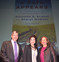 Three people pose in front of 