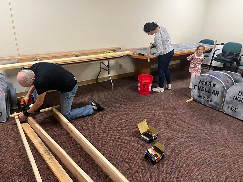 Helpers working on wood for the housing