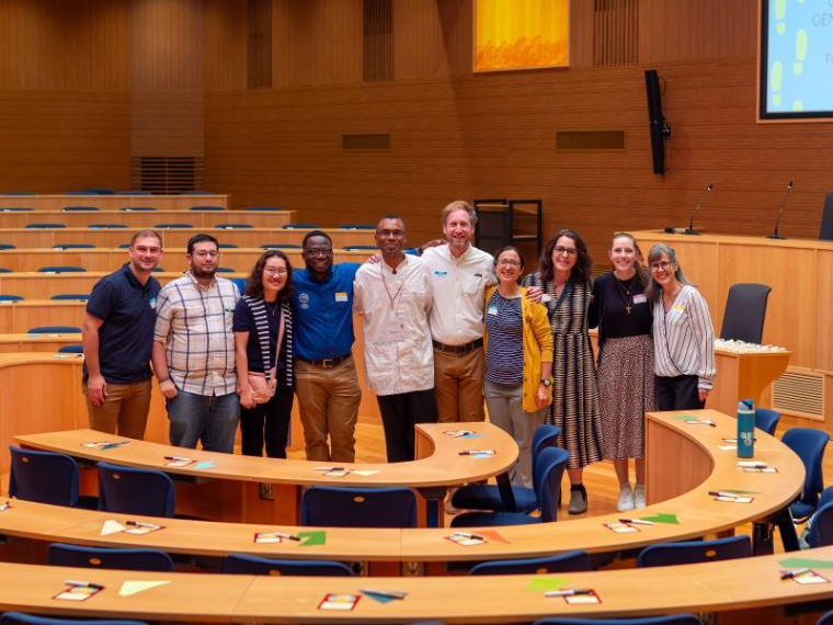 Group photo inside a modern meeting room.