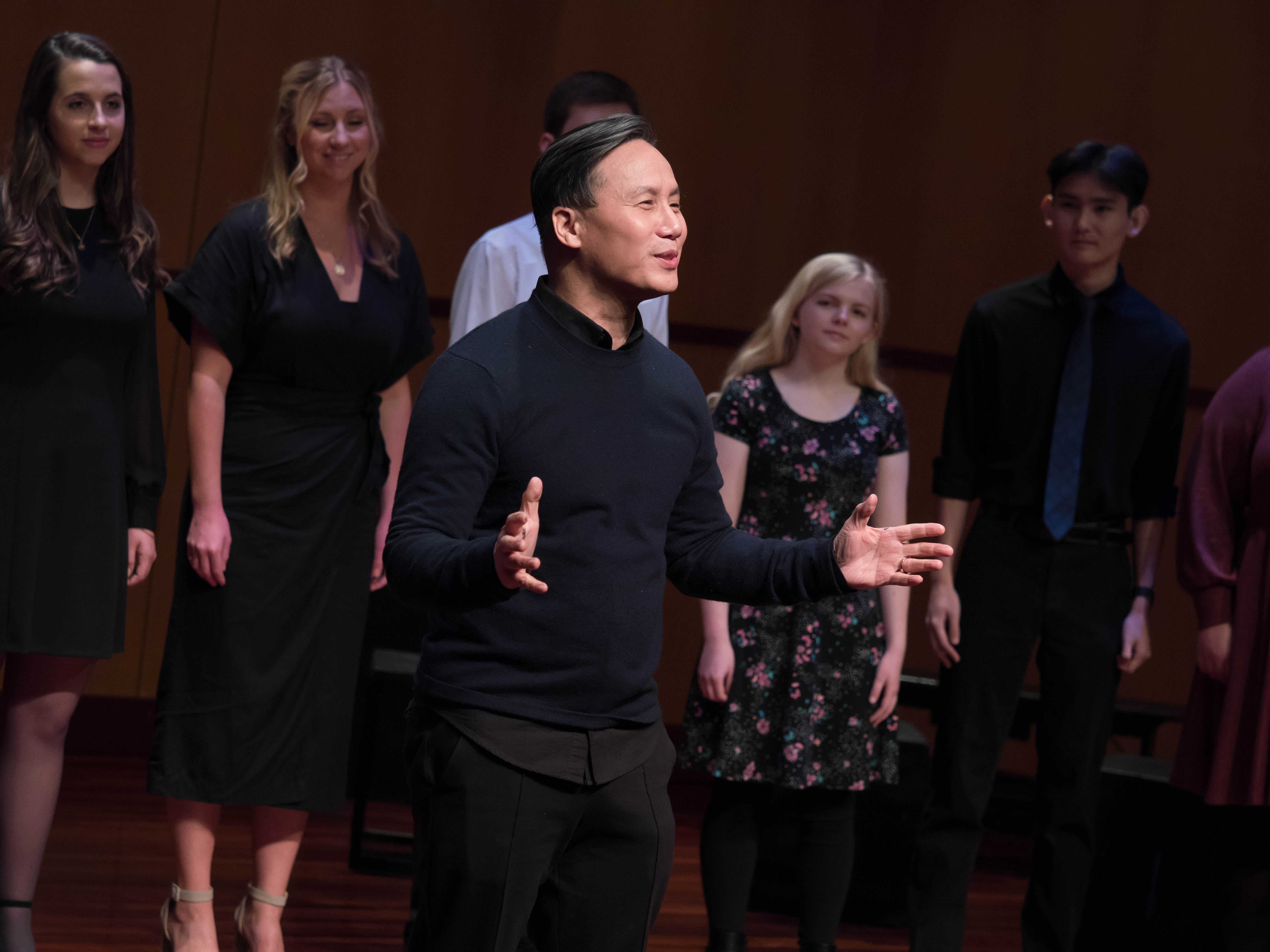 A group of performers rehearsing on stage.