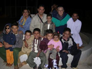 A group of people posing together at night.