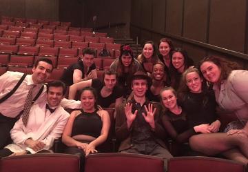 A group posing in theater seating, titled 'Dance Ensemble'.