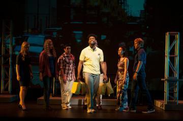 A group of six people are having a discussion on stage.