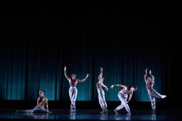 5 posed dancers in brown sleeveless tops and khaki pants