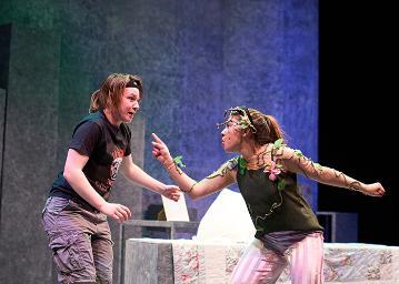 A boy talking to a girl who has roses growing out of her skin