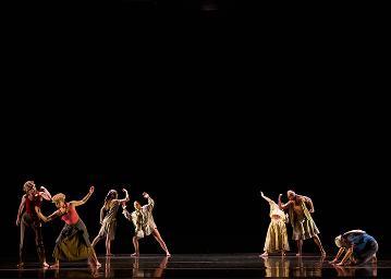 Groupings of dancers dressed as migrant workers