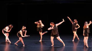 6 female dancers in black tees & shorts