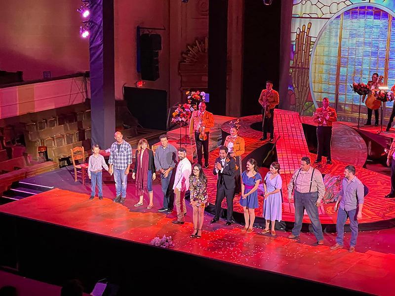 Director Karina Gutierrez joins her cast for the curtain call at Cruzar la Cara de la Luna's opening night