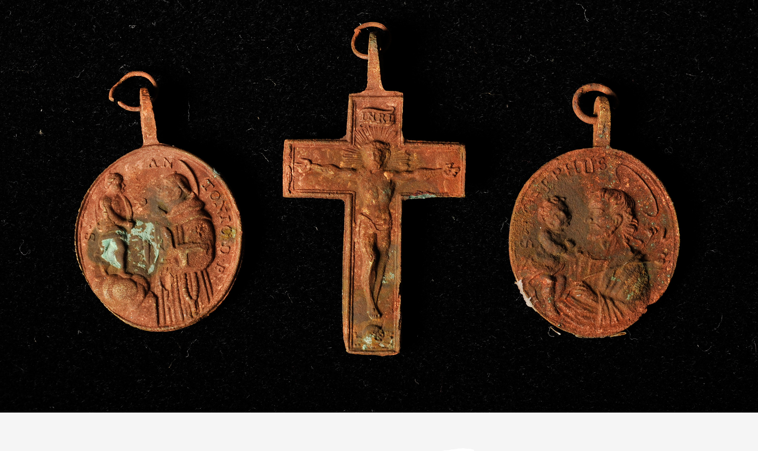 Two metal coins and a cross placed in the third mission cornerstone by Father Junipero Serra.