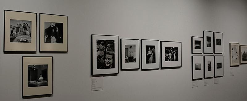 Installation view of gallery wall featuring framed black and white photographs
