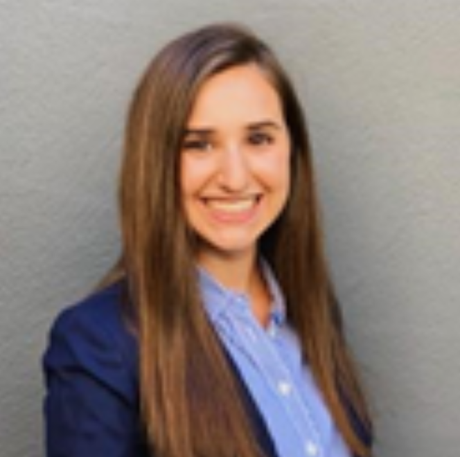 A person smiling in a blue blazer and shirt.