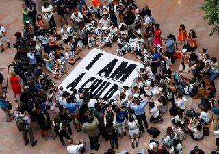 Families with young children protest the separation of immigrant families with a sit-in at the Hart Senate Office Building, Thursday, July 26, 2018, on Capitol Hill in Washington.  (AP Photo/Jacquelyn Martin)