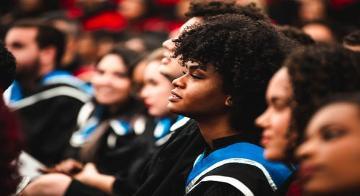 an African American professor attending a ceremony with colleagues