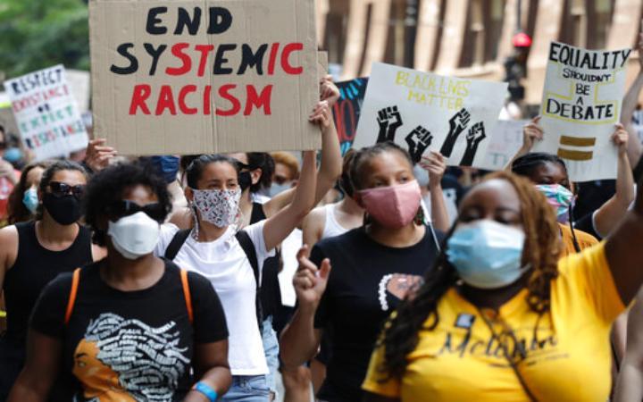 protesters marching against systemic racism