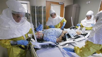 In this file photo from Oct. 28, 2006, a mock patient is cared for during a drill at the Nebraska biocontainment unit in the Nebraska Medical Center in Omaha, Neb. (AP Photo/Nati Harnik)