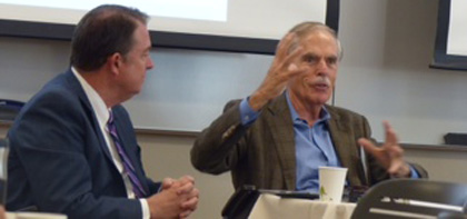 Two men in discussion during a meeting or conference.