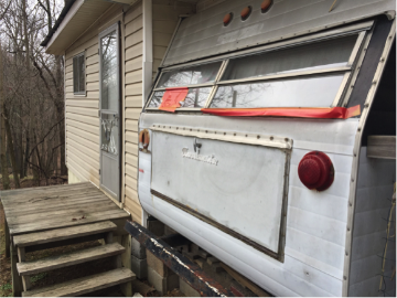 Bullet holes can still be seen on the surface of Larry’s trailer home situated in Stanley Heirs Park. Later he moved into a cabin, upon which words read “Love Them or Leave Them Just Don’t Destroy Them” [6]