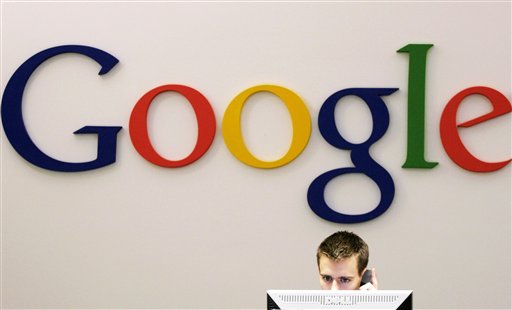 A person using a laptop in front of a Google logo. image link to story