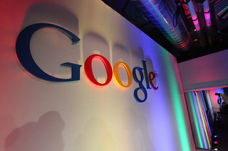Google logo on a wall with colorful lighting effects. image link to story