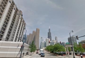 Street view of downtown Chicago with skyscrapers and pedestrians.