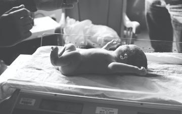 newborn being weighed on scale